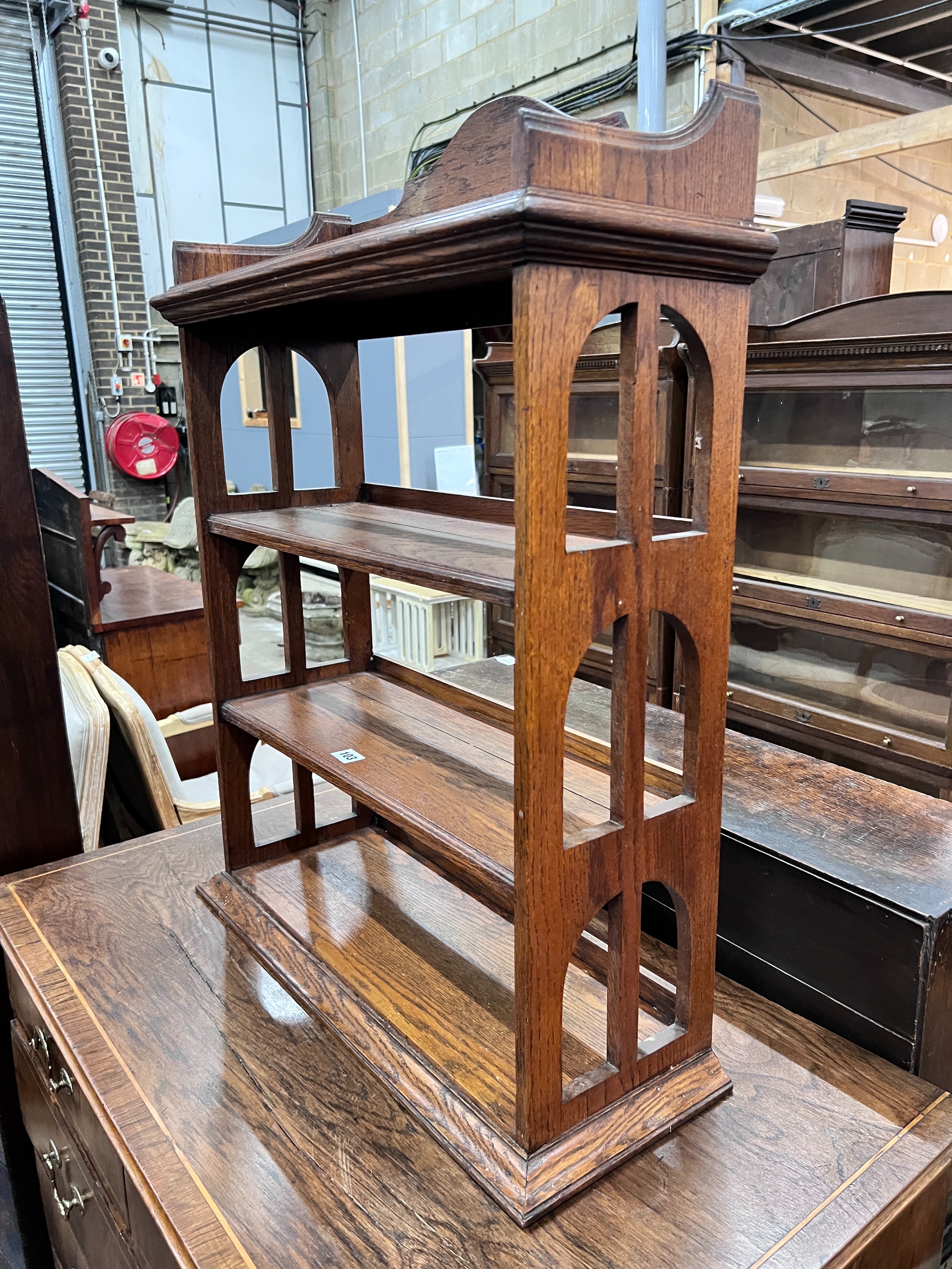An Edwardian oak table top four tier open bookcase, width 62cm, depth 23cm, height 81cm *Please note the sale commences at 9am.